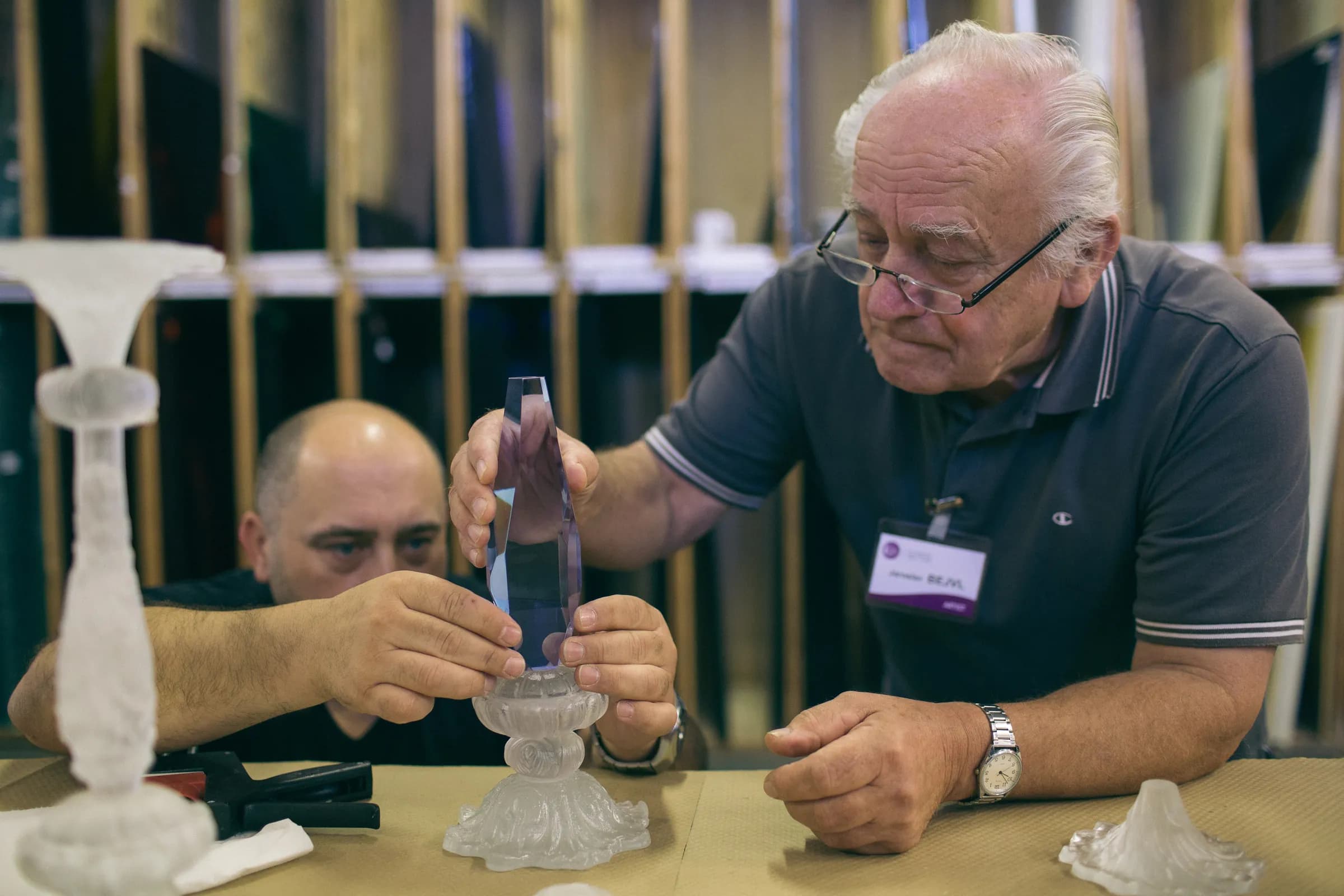 Jaroslav Bejvl Jr. and Sr. assembling the glass parts of a candelabrum