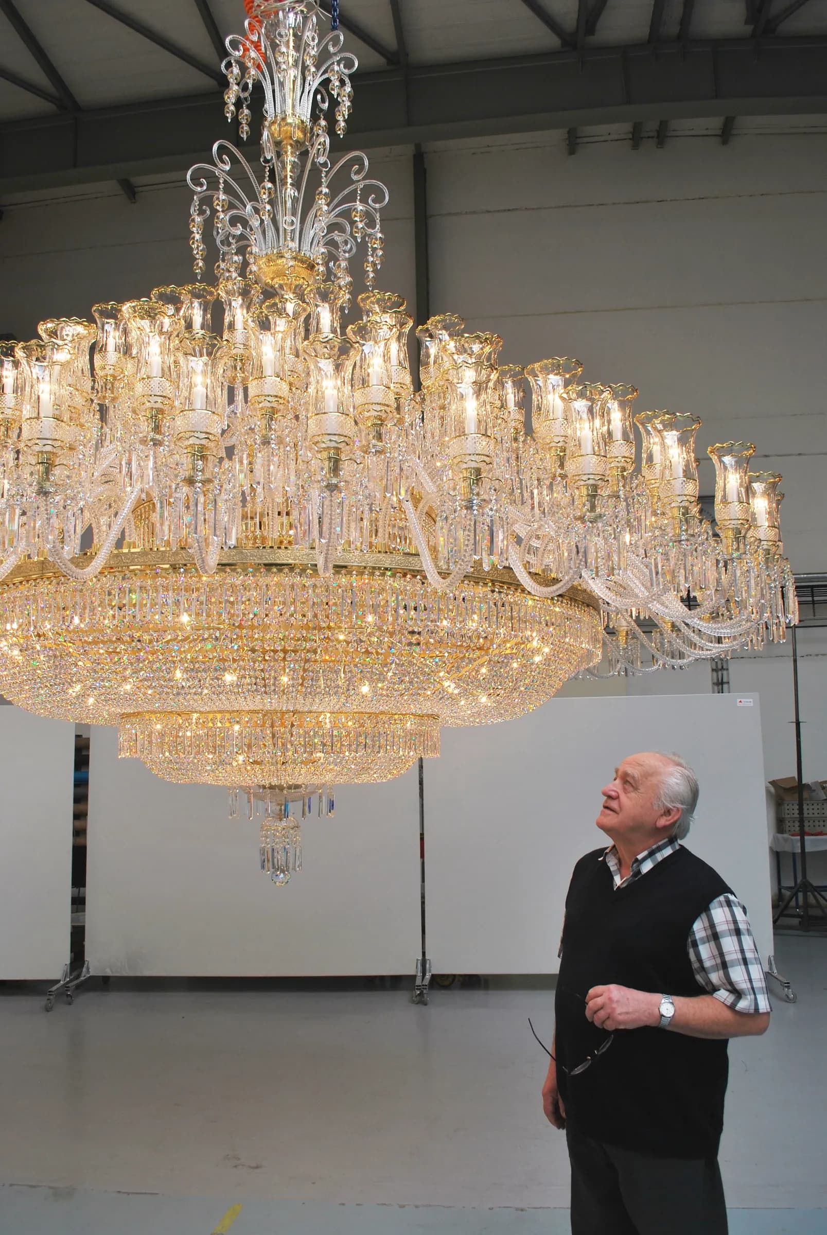 Jaroslav Bejvl Sr. beneath a crystal chandelier in the assembly hall